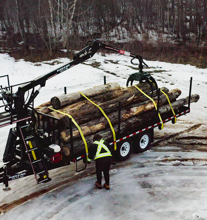 Drone photo of Road Forestry Trailer with load of logs being strapped down